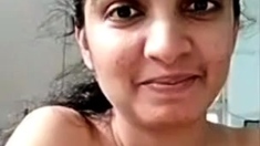 Busty indian milf strips nude to show round tits on webcam